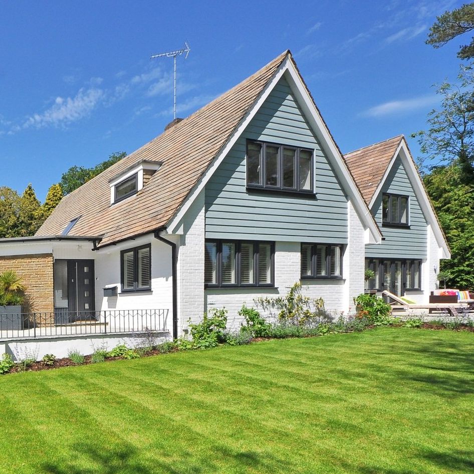 A large house with a lush green lawn in front of it