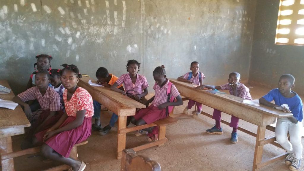 A group of children are sitting at desks in a classroom.