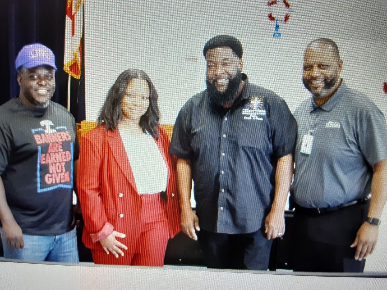 A group of people standing next to each other with one wearing a shirt that says 