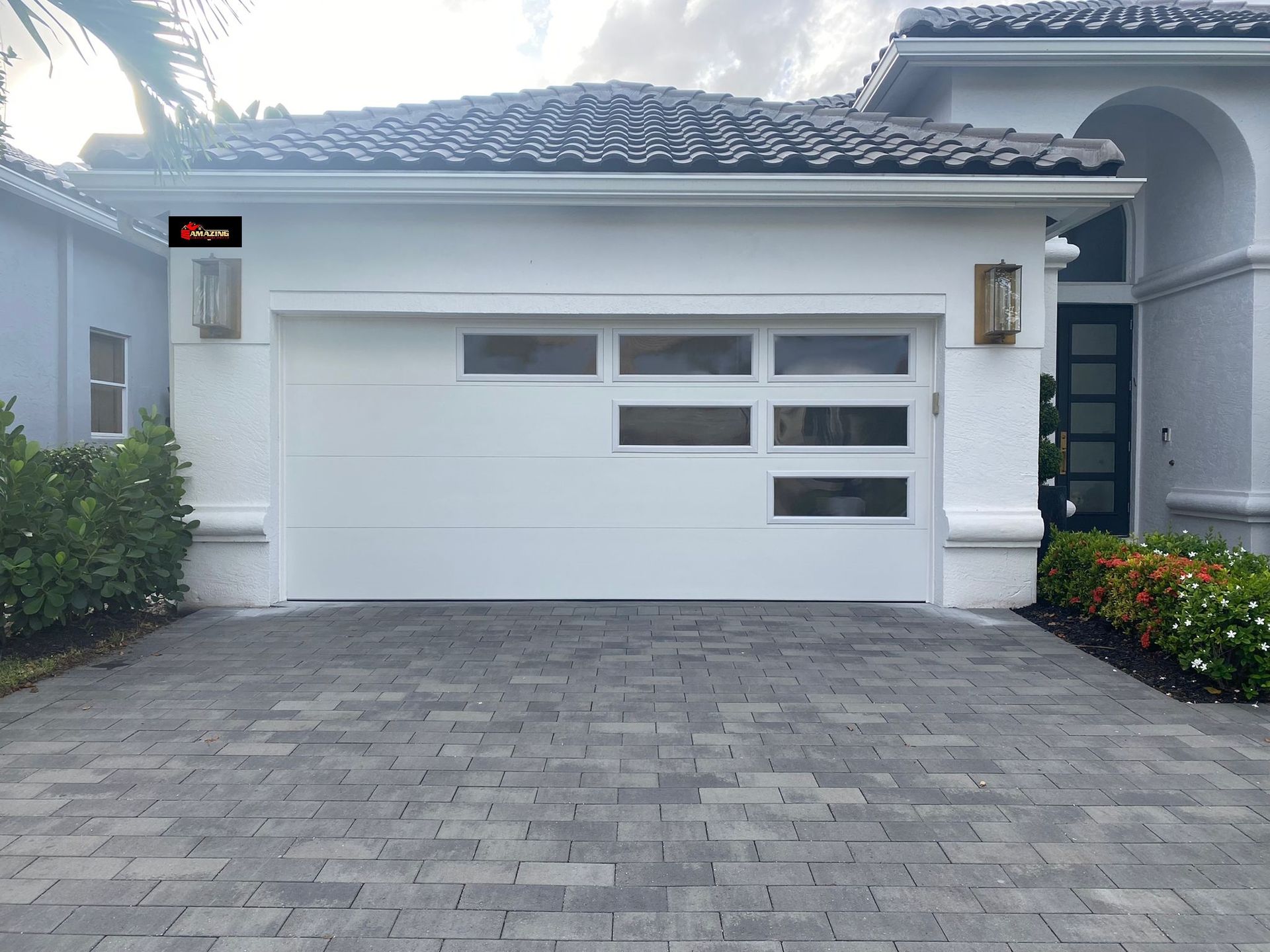 Yellow garage door with a textured surface and windows at the middle.