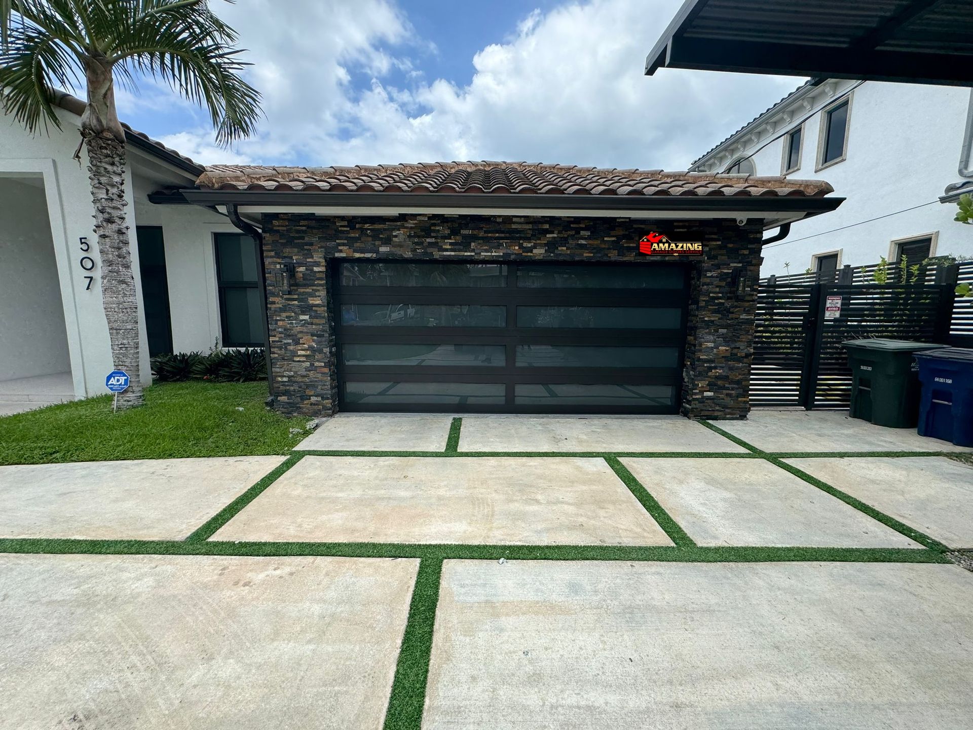 A large garage door is sitting in the driveway of a house.