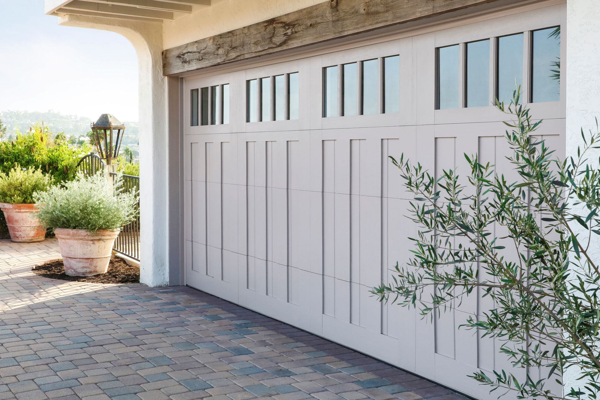 Yellow garage door with a textured surface and windows at the middle.