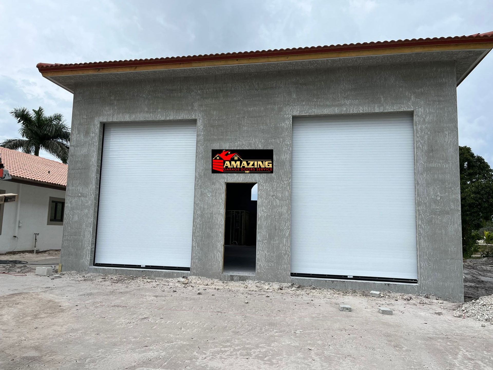 Yellow garage door with a textured surface and windows at the middle.