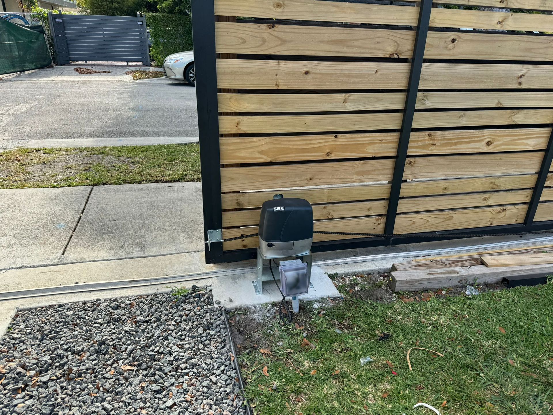 Opening automatic garage door with ceiling-mounted electric engine gear and emergency cord