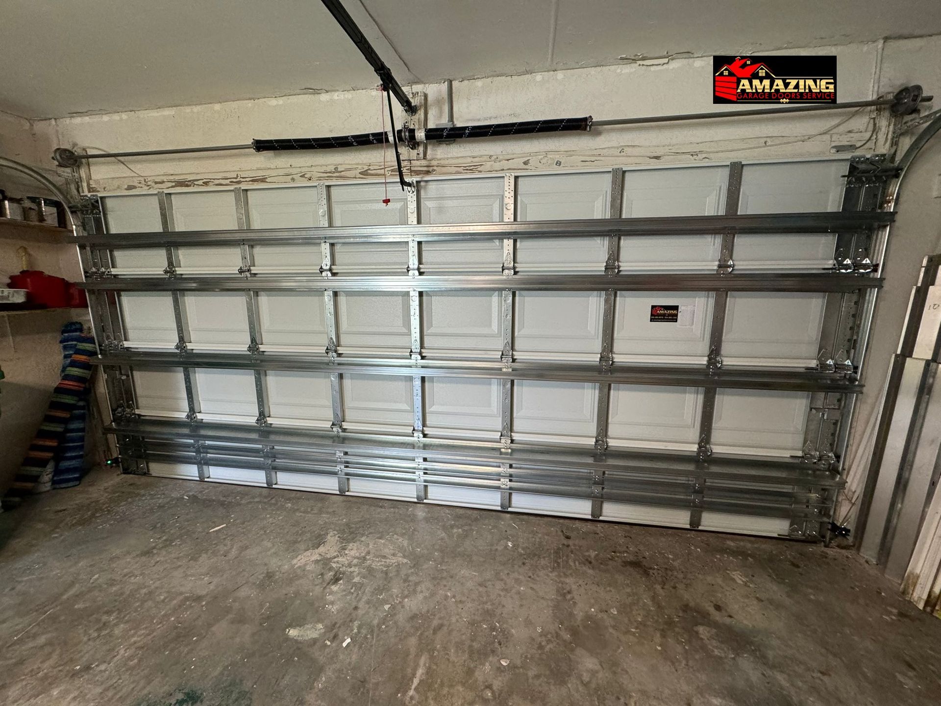 Yellow garage door with a textured surface and windows at the middle.