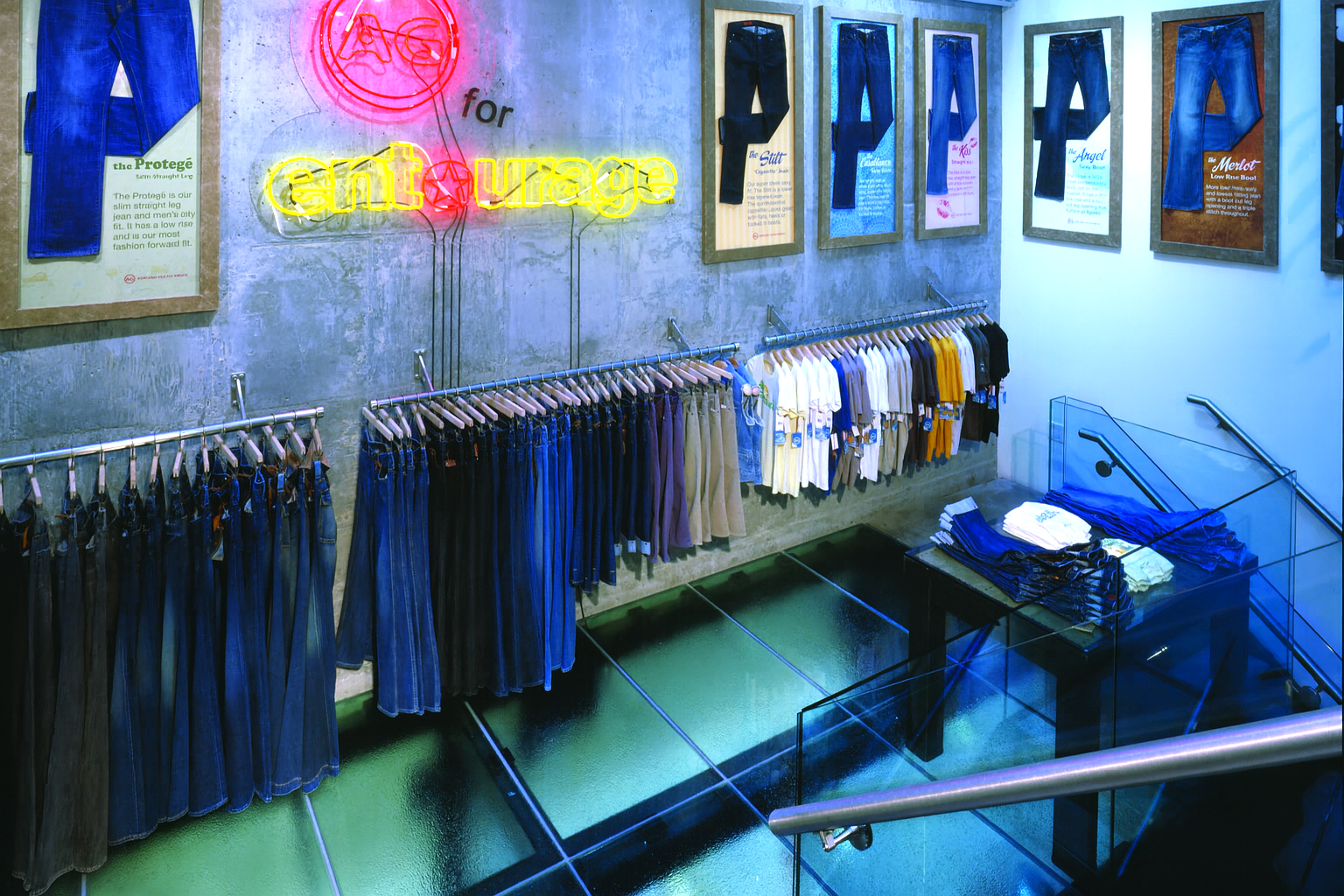 Jeans retail store interior with rows of jeans on display, neon sign, and framed denim.