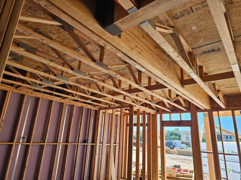 The Inside Of A Building Under Construction With A Lot Of Wooden Beams