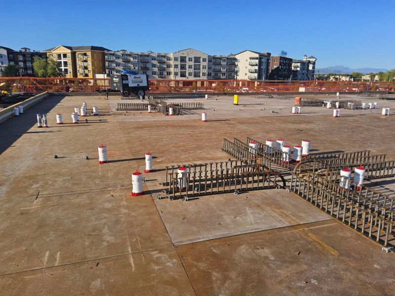An Aerial View Of A Construction Site With Buildings In The Background