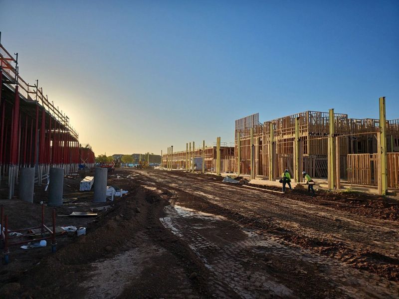 A Construction Site With A Lot Of Dirt And A Blue Sky In The Background