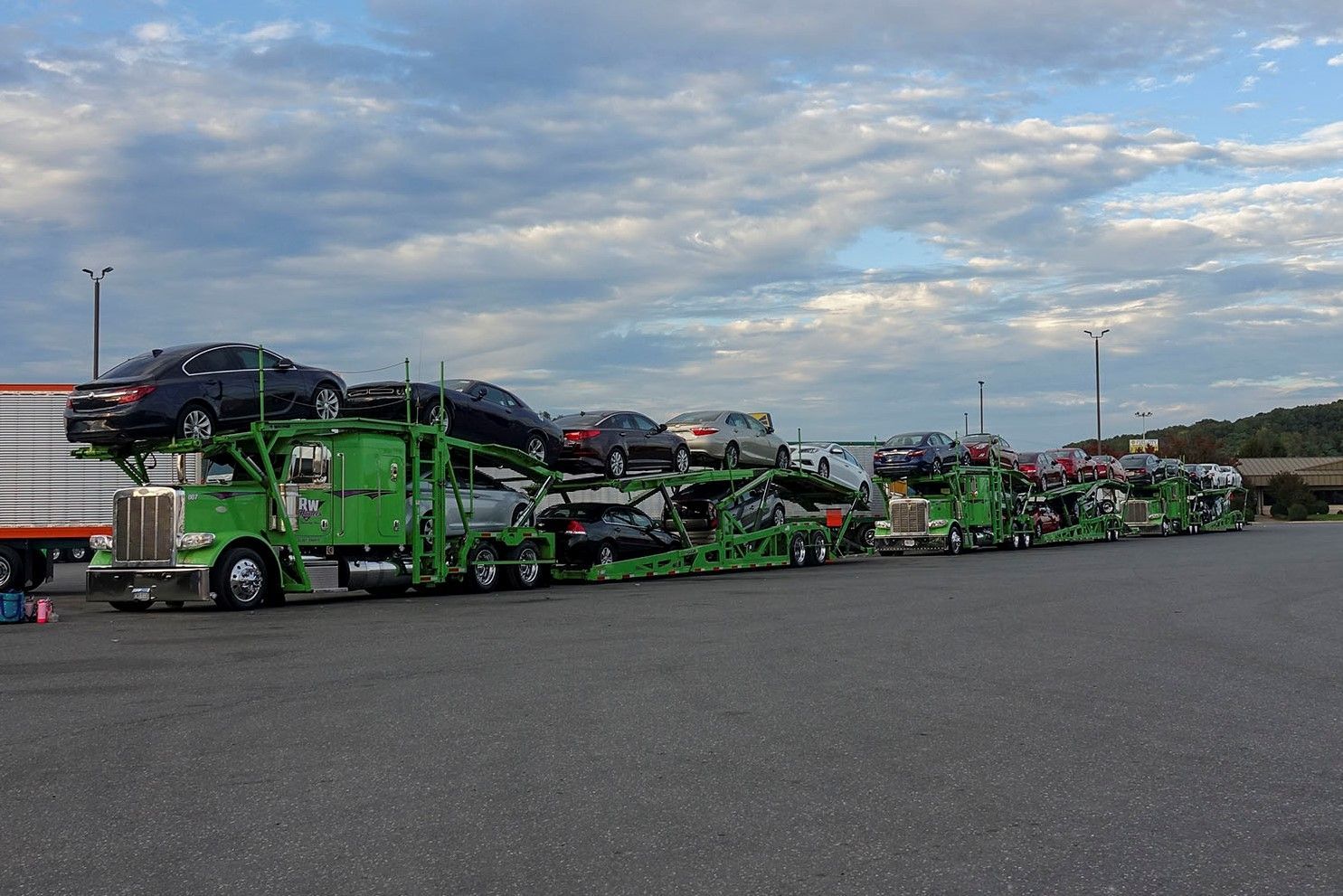 2 RW Hauler trucks carrying a full load of cars