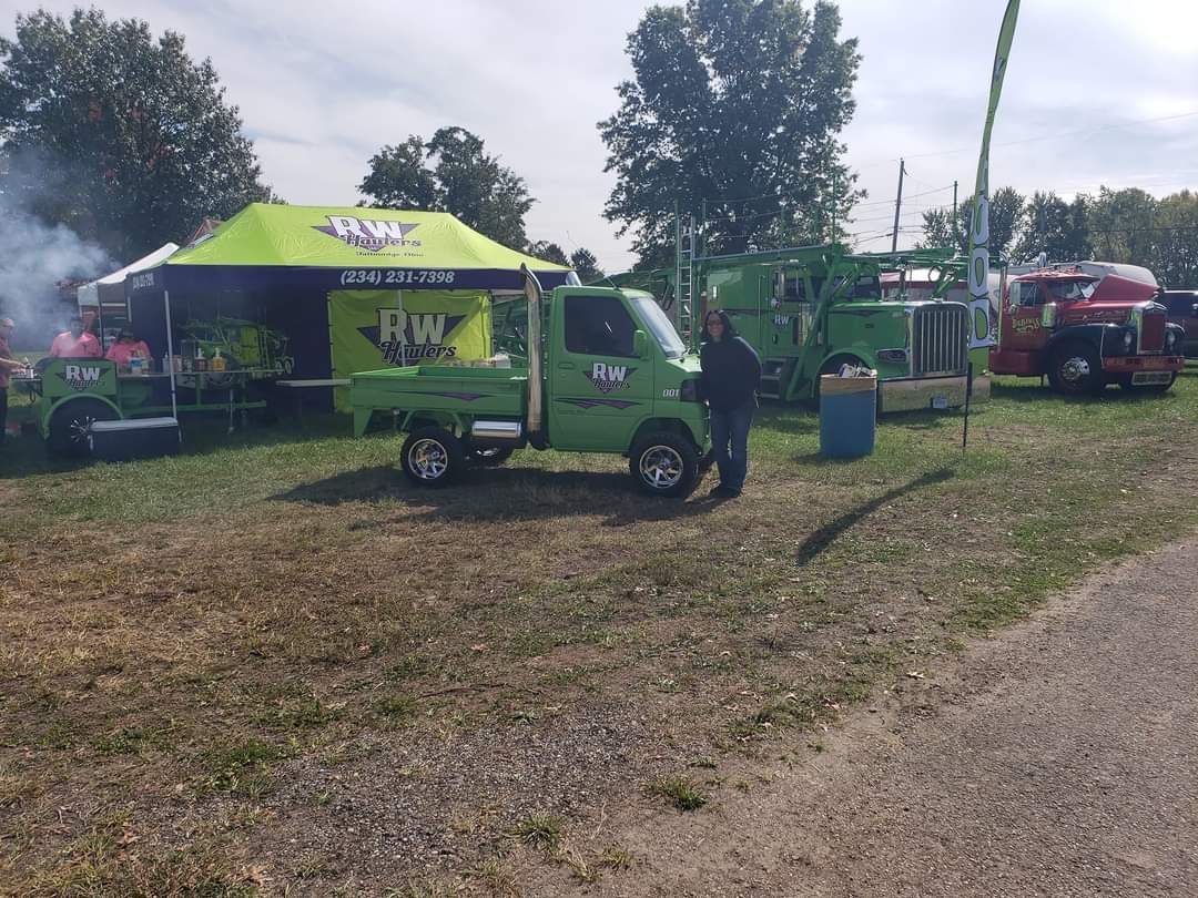 RW Hauler mini-truck at outdoor event with tent