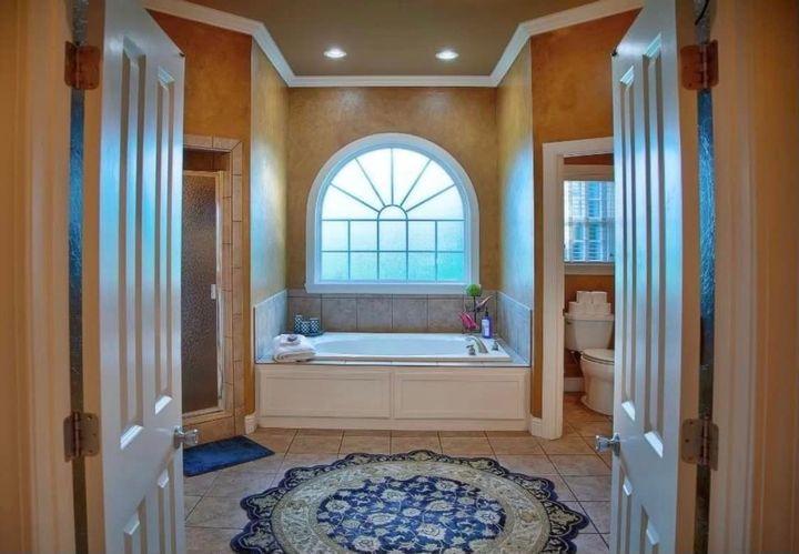 a bathroom with a tub and a window