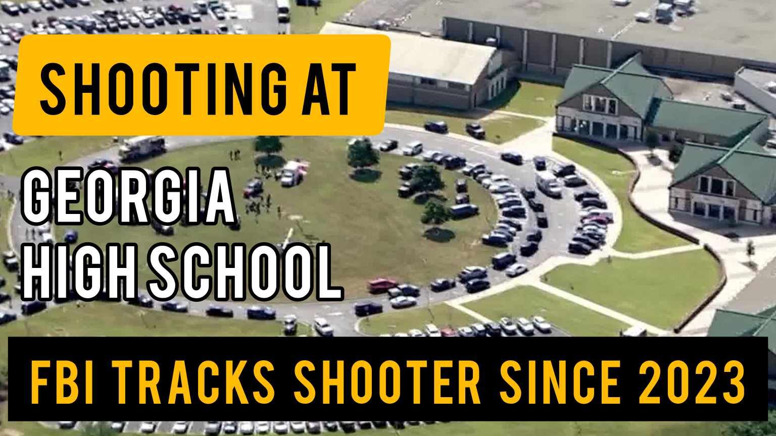 An aerial view of a georgia high school with cars parked in front of it.