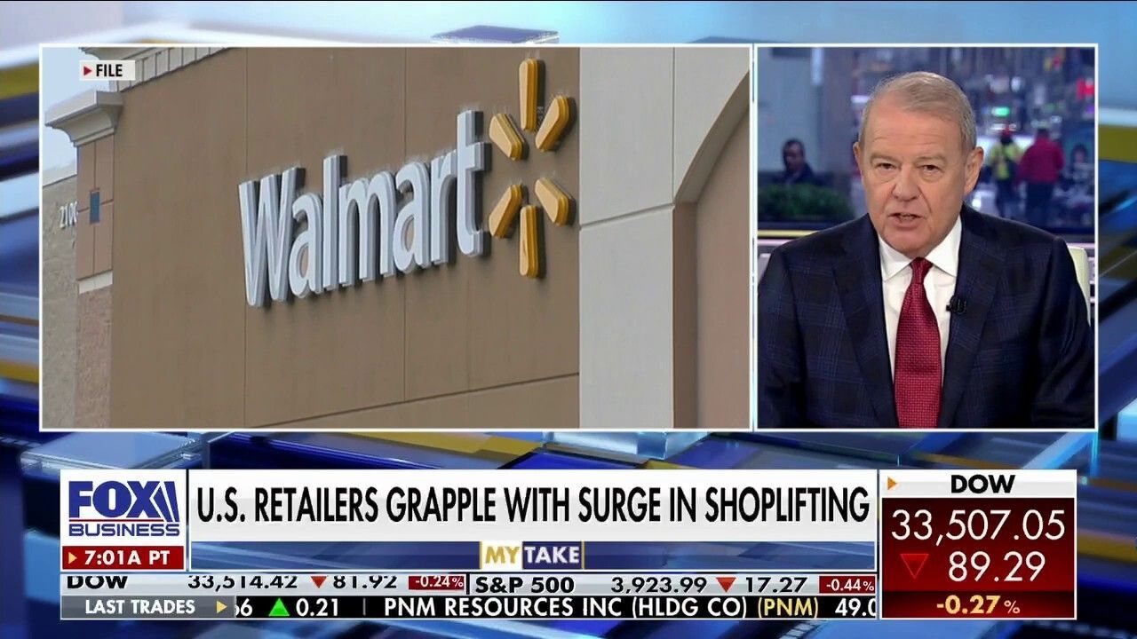 A man in a suit and tie is talking about walmart