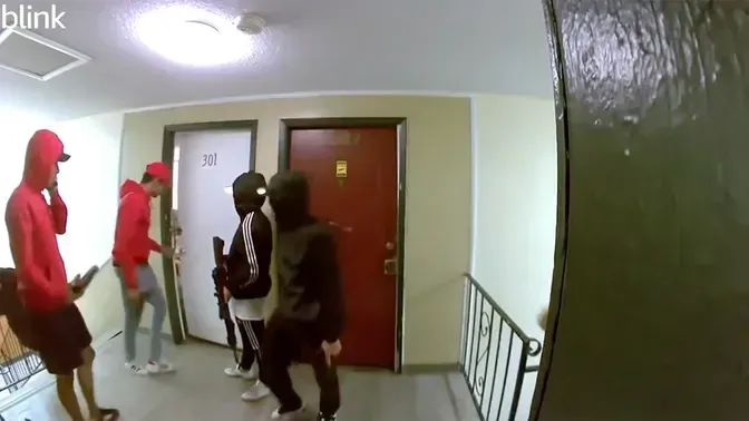 A group of people are standing in a hallway.