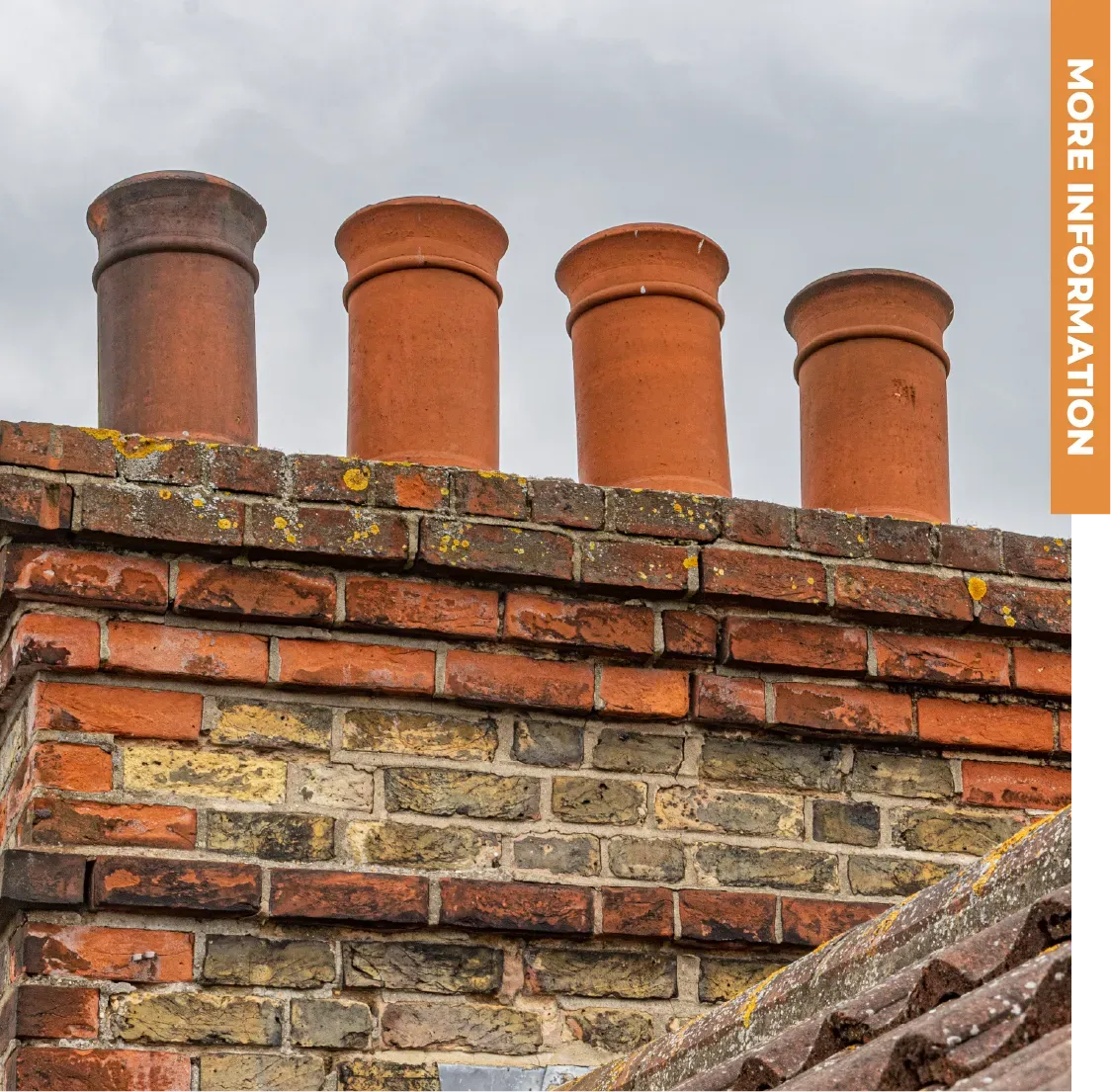 A brick chimney with four chimneys on top of it