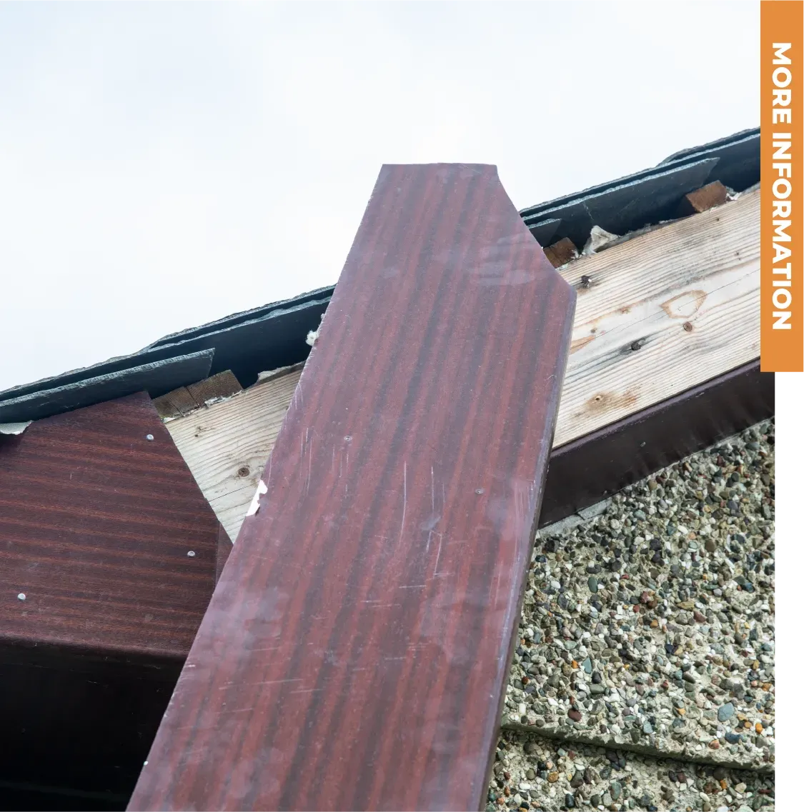 A wooden coffin is sitting on top of a concrete wall