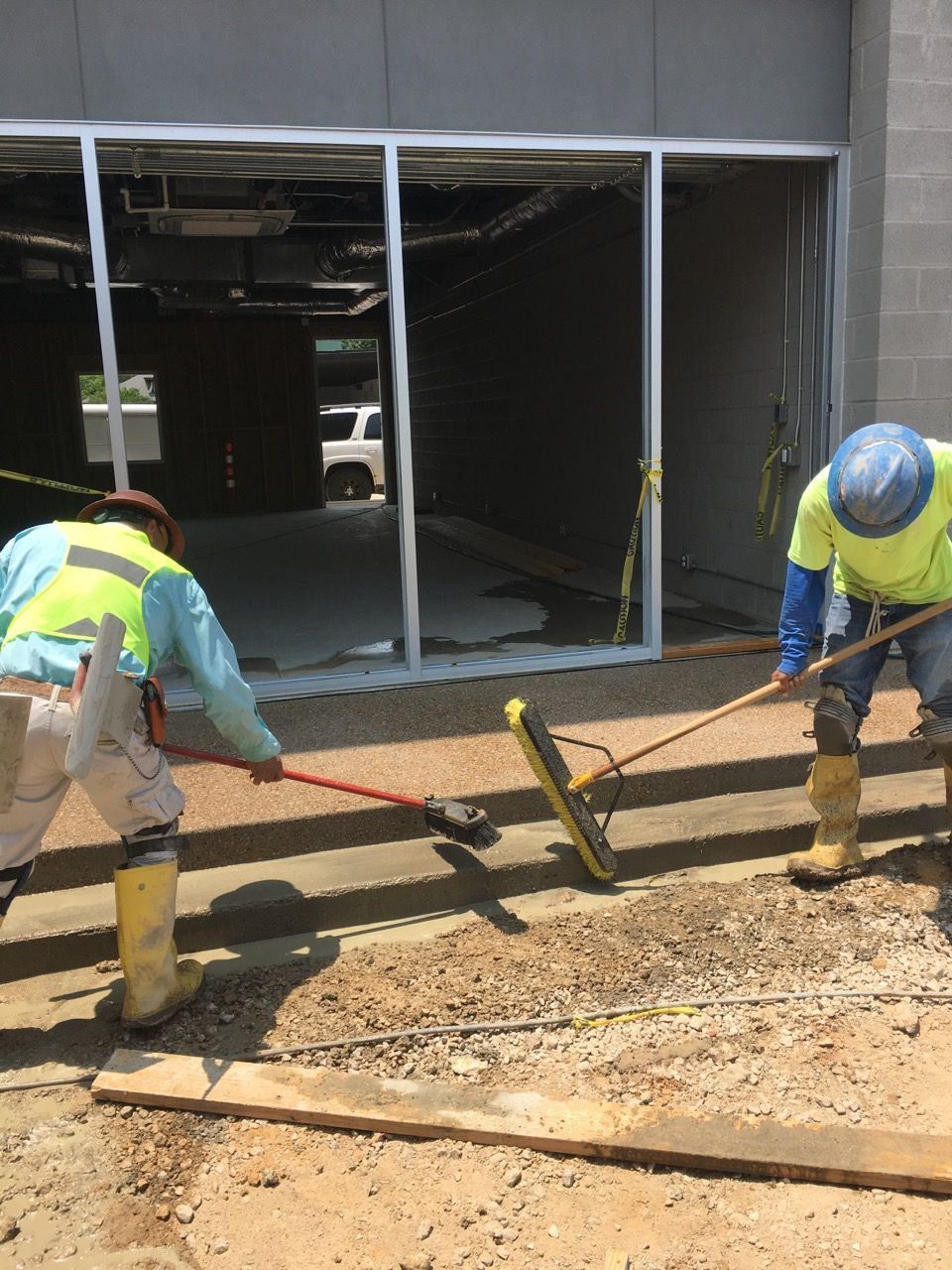Construction Workers are working on a Sidewalk in front of a Building - Rockwall, TX - G & G Construction Co.