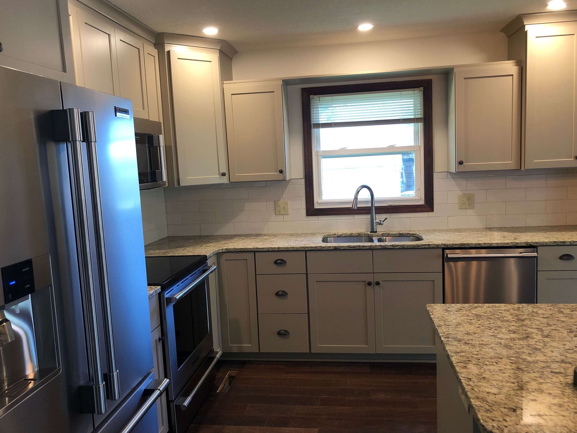 A kitchen with white cabinets and stainless steel appliances