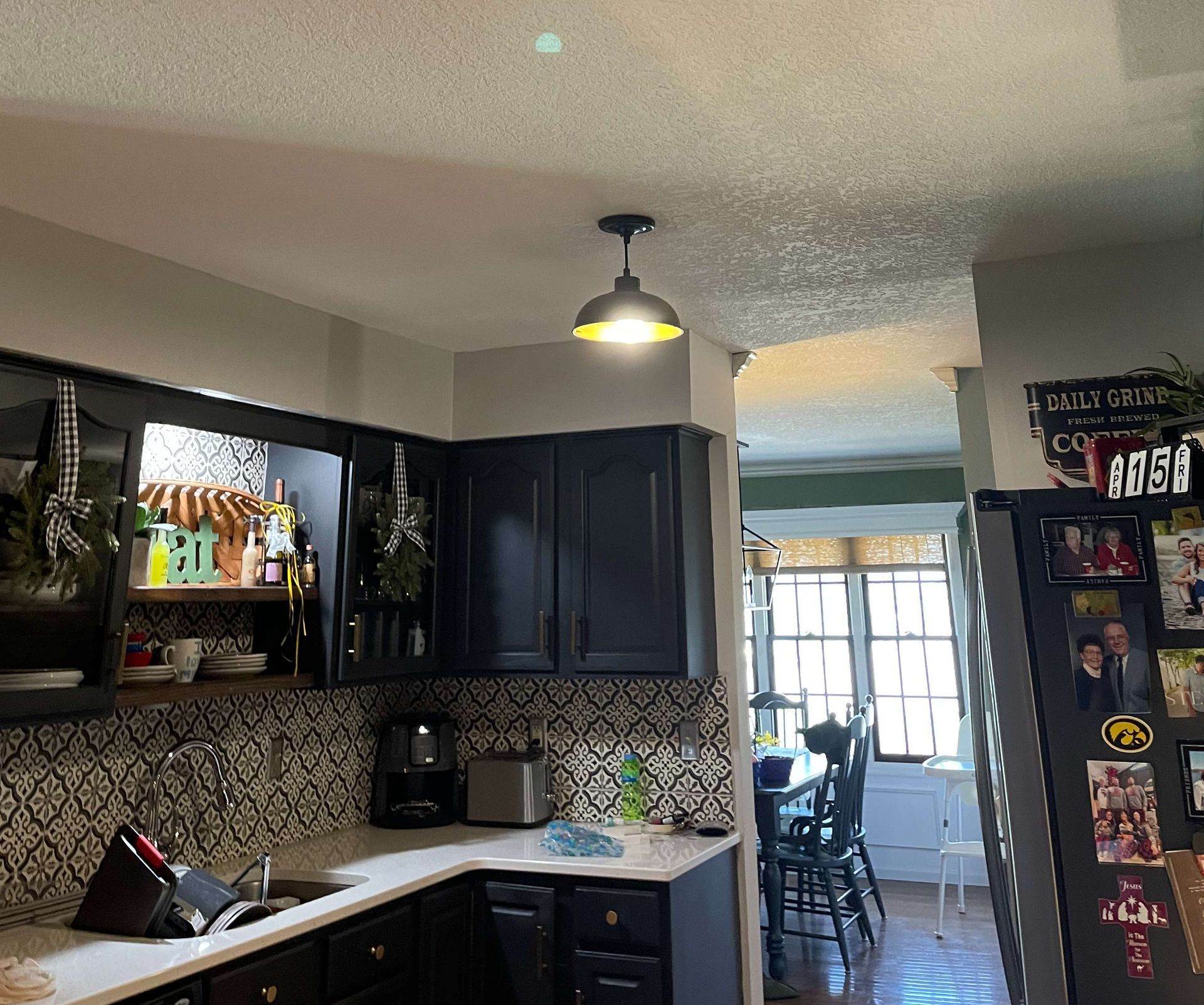 A kitchen with black cabinets and white counter tops