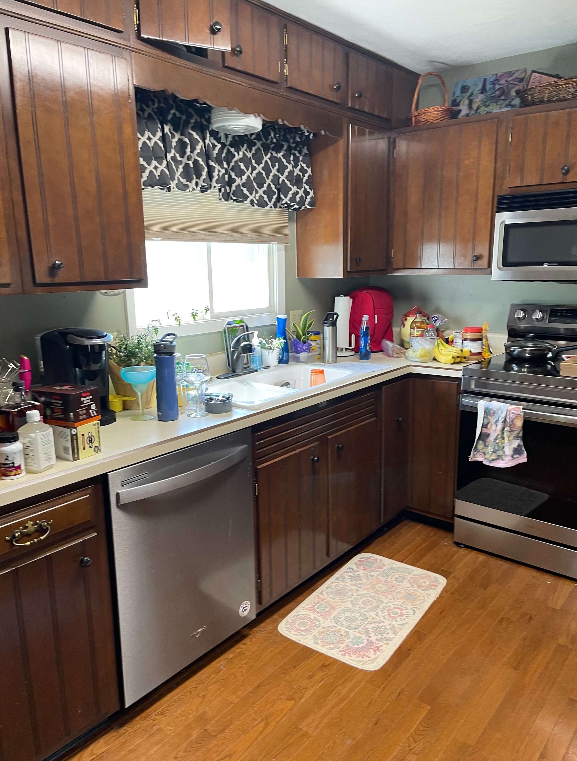 A kitchen with wooden cabinets and stainless steel appliances.