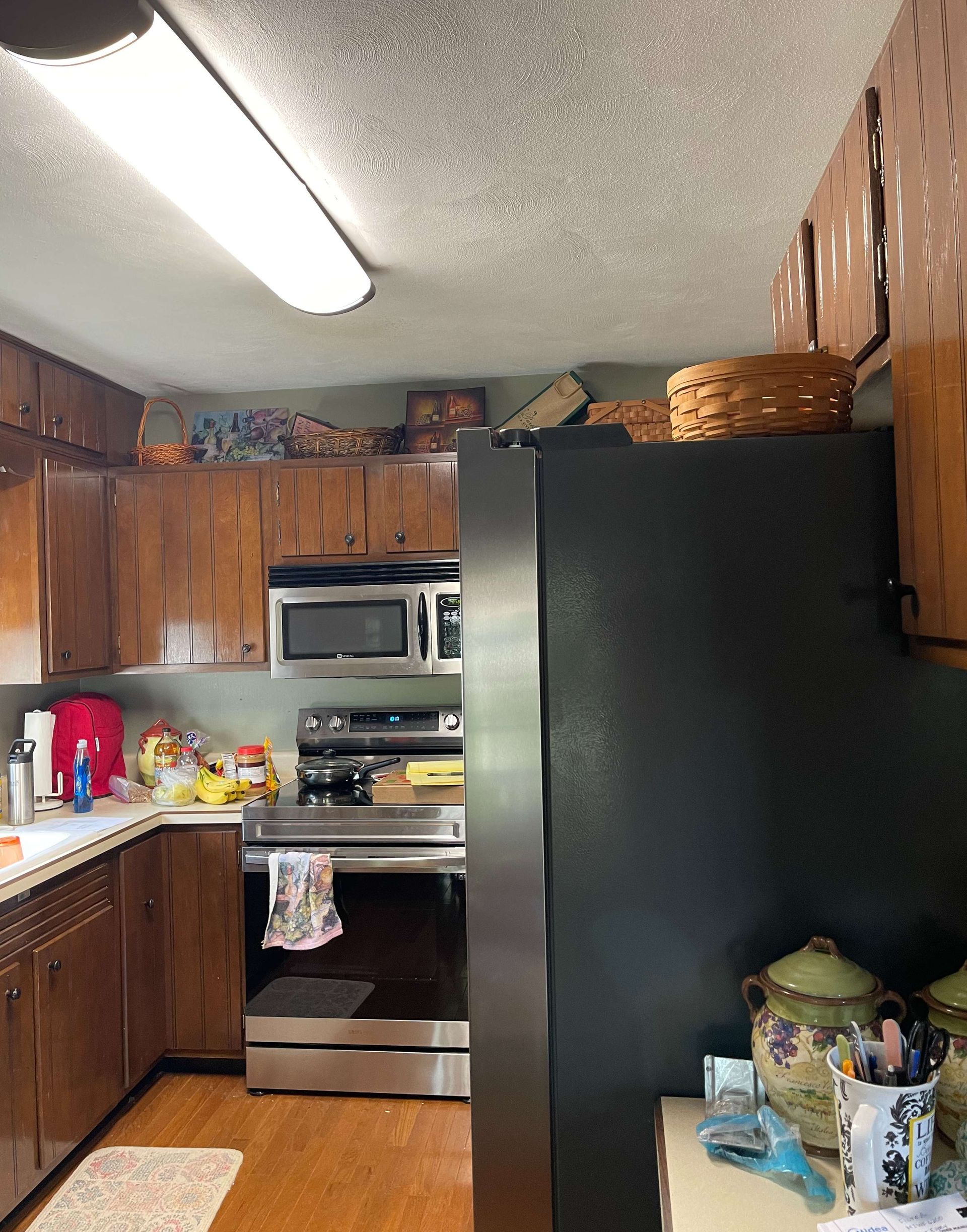 A kitchen with stainless steel appliances and wooden cabinets