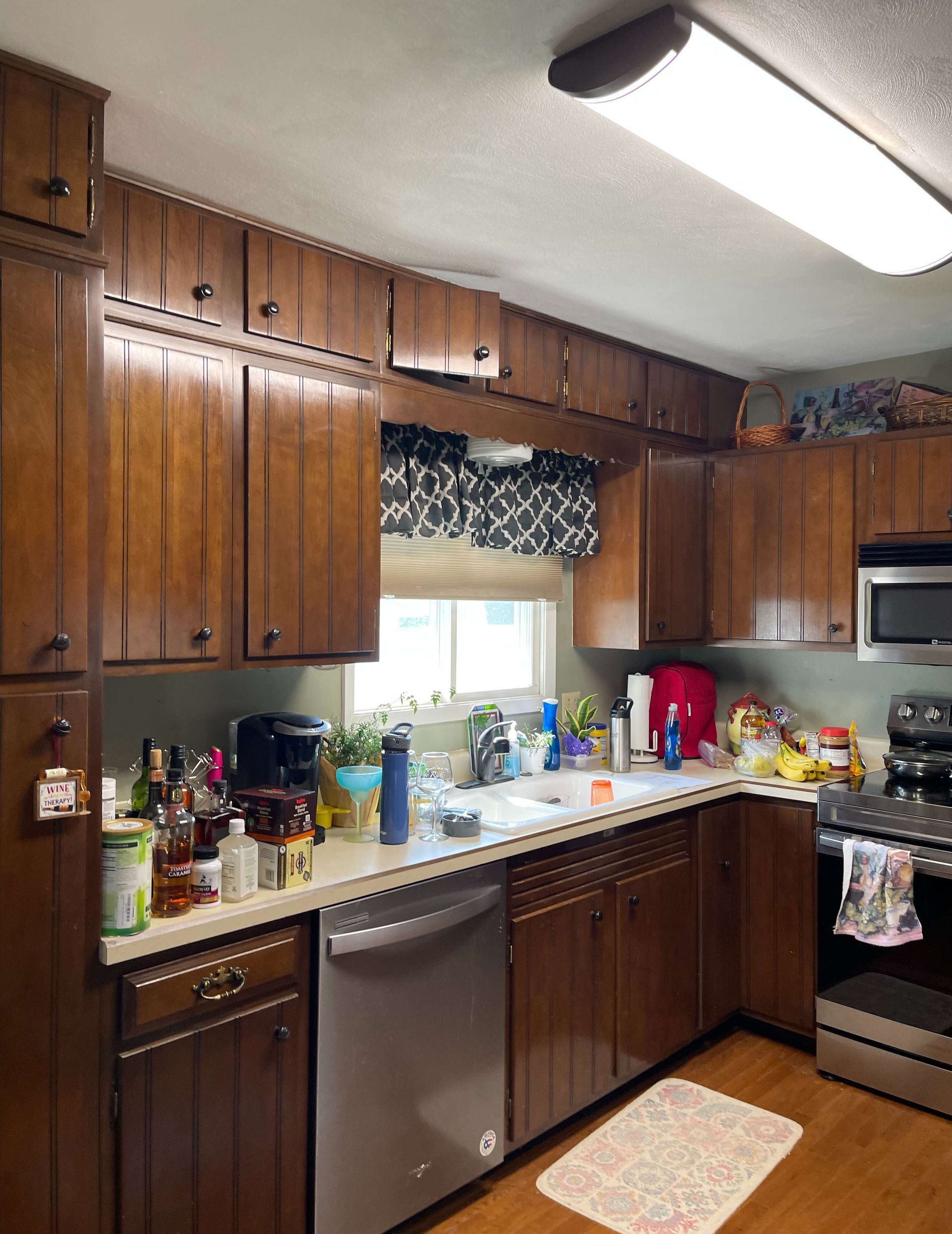 A kitchen with wooden cabinets and stainless steel appliances