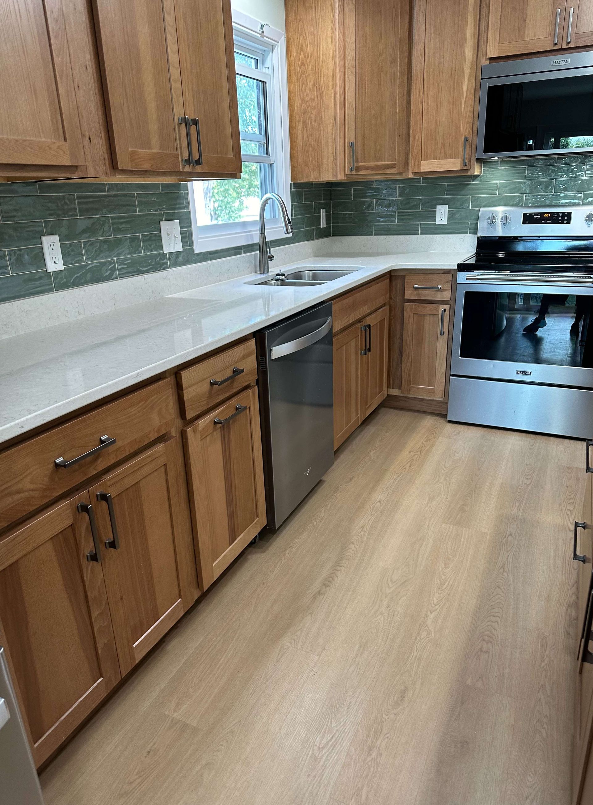 A kitchen with wooden cabinets and stainless steel appliances.