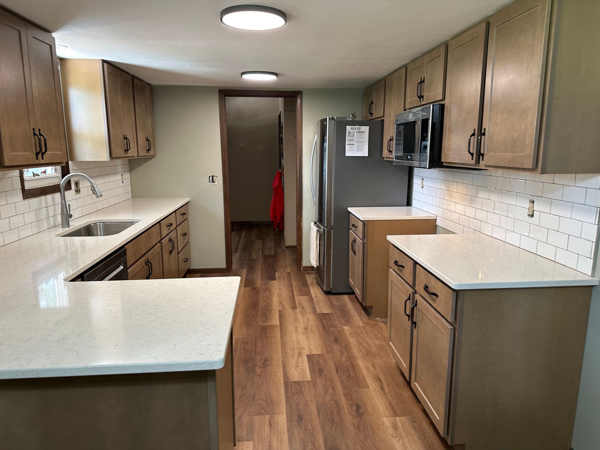 A kitchen with stainless steel appliances and wooden cabinets