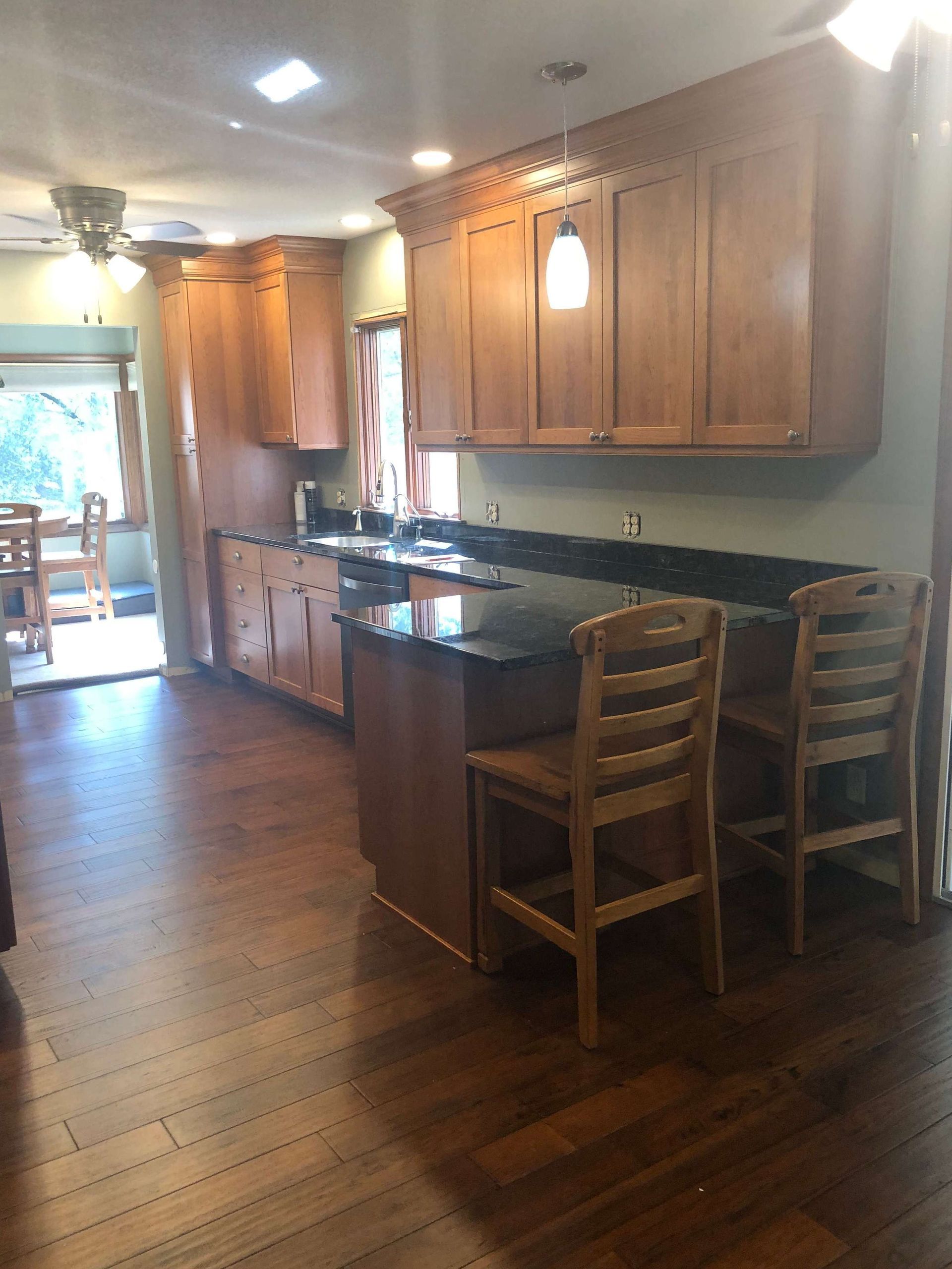 A kitchen with wooden cabinets and granite counter tops