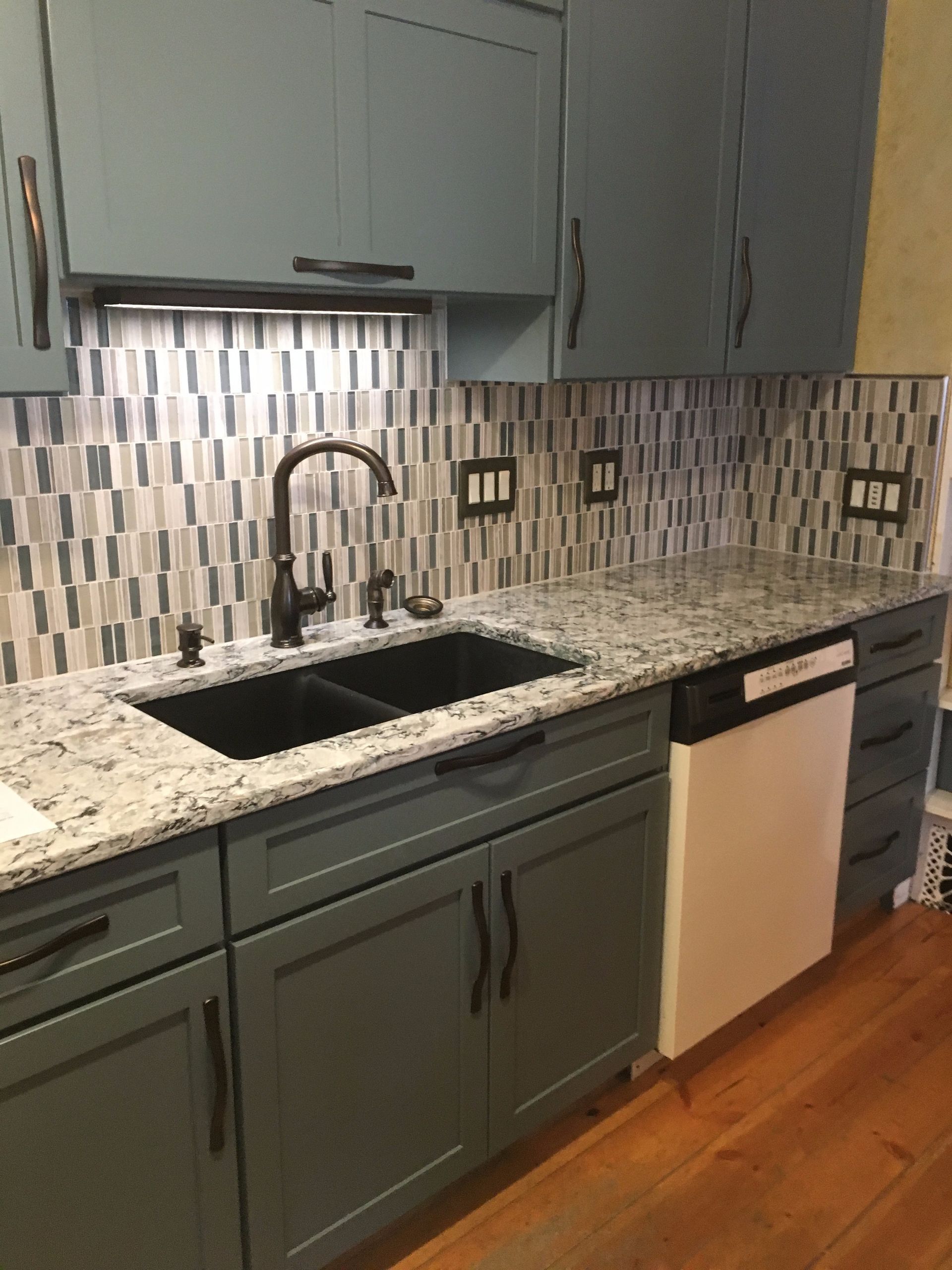 A kitchen with blue cabinets and granite counter tops
