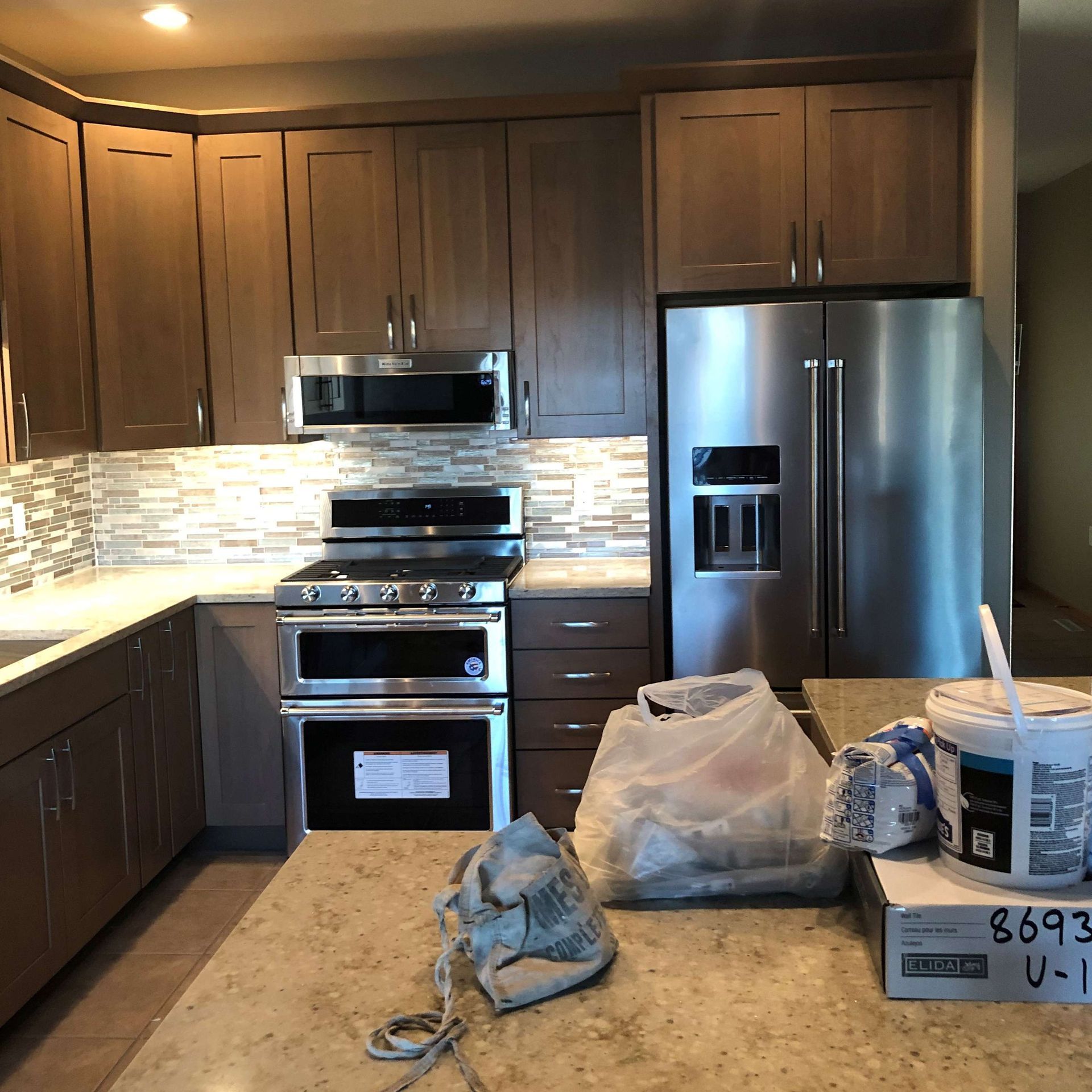A kitchen with stainless steel appliances and wooden cabinets