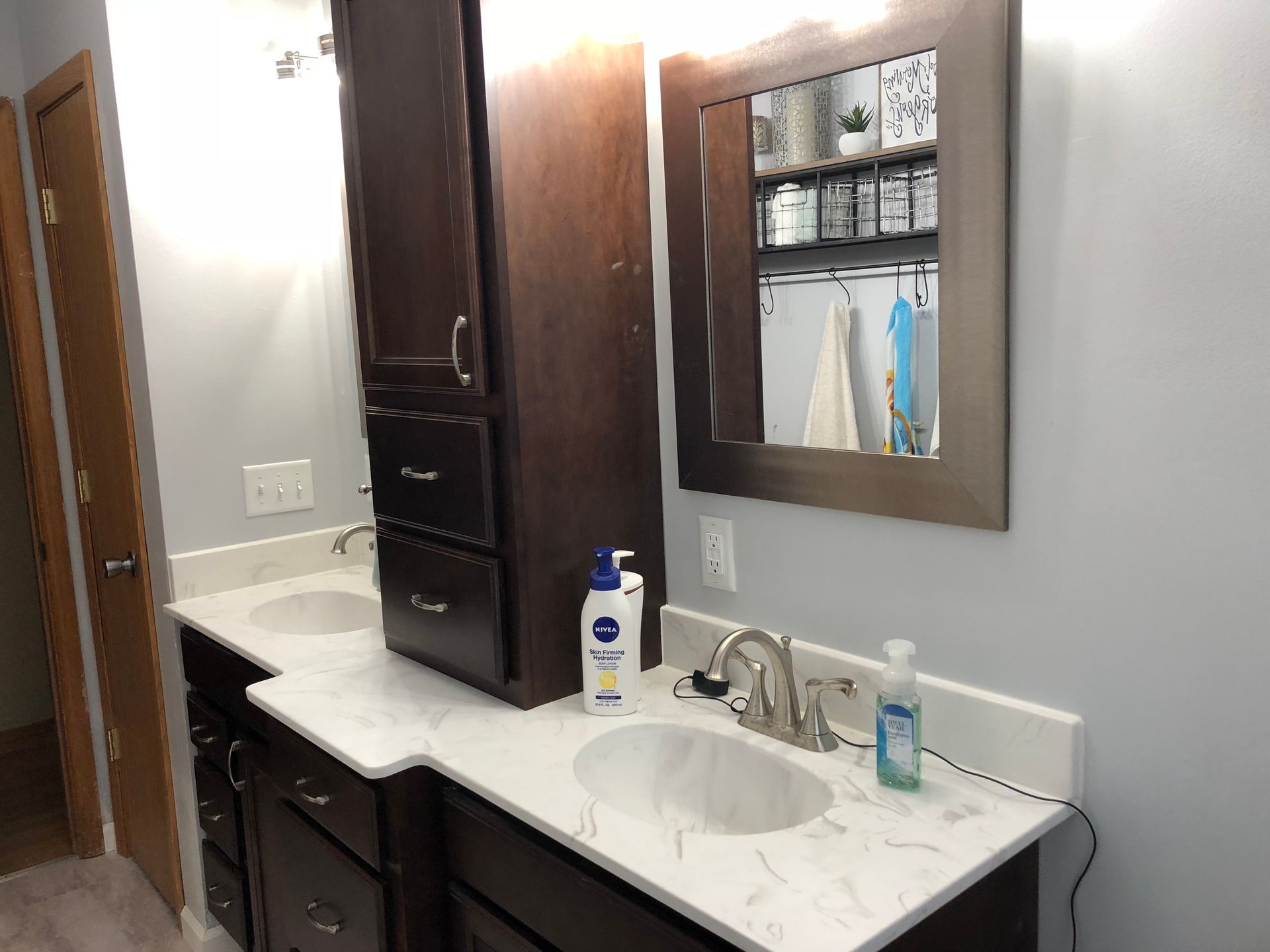 A bathroom with two sinks and a mirror.