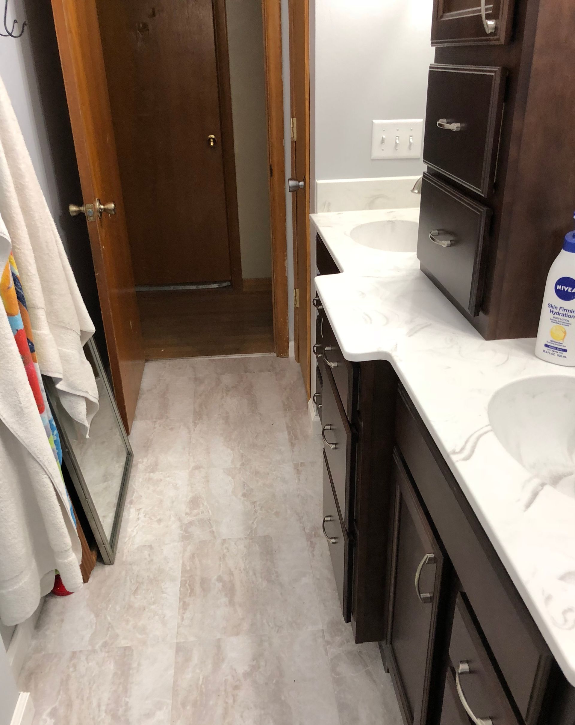 A bathroom with two sinks and a mirror