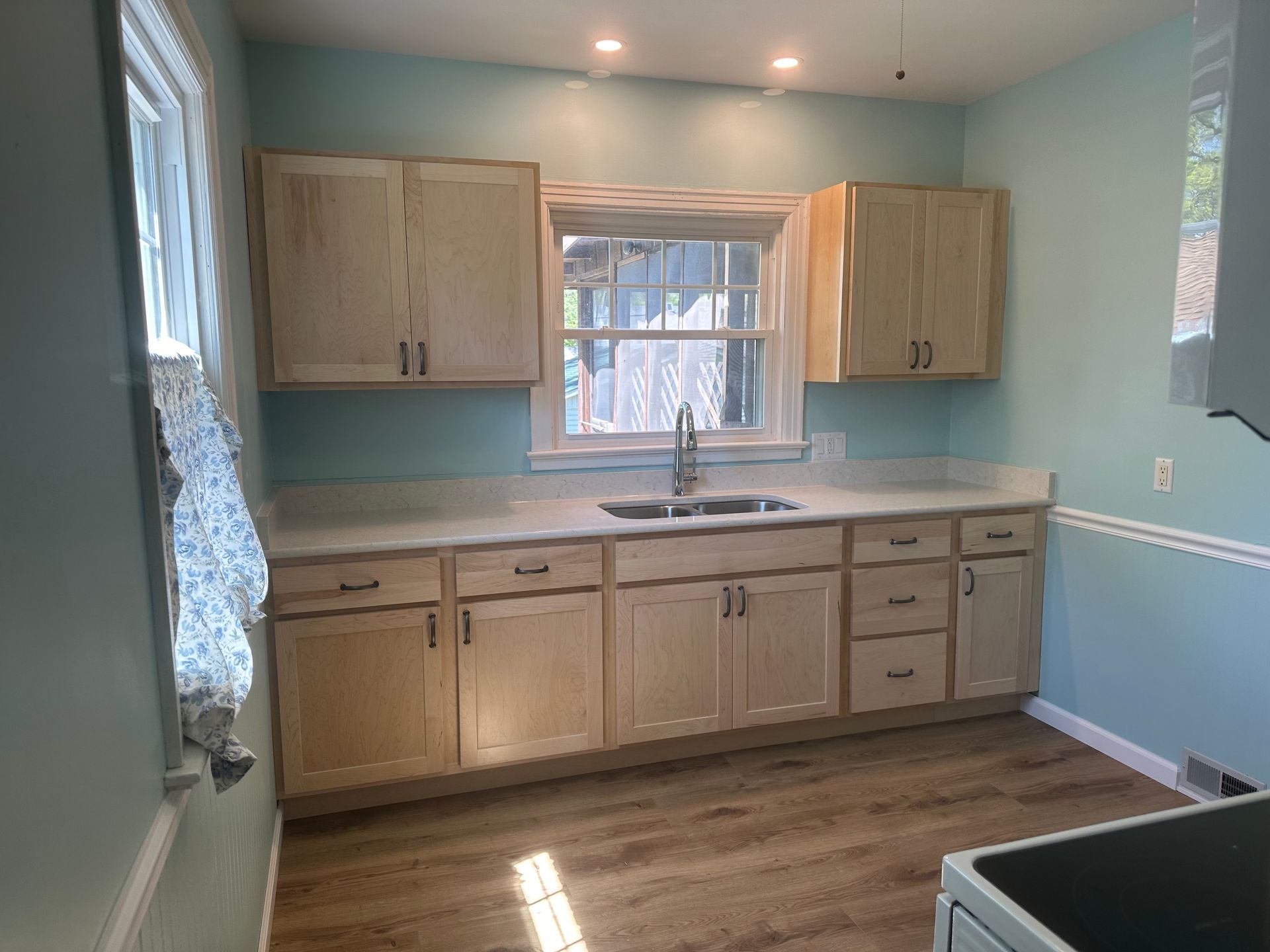 A kitchen with wooden cabinets and a sink