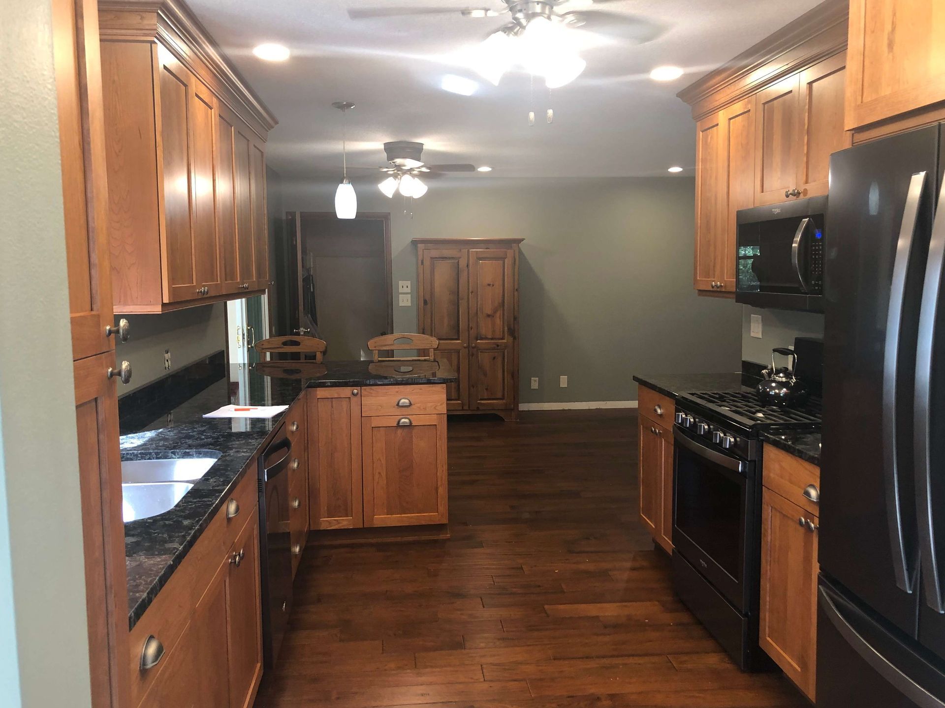 A kitchen with stainless steel appliances and wooden cabinets