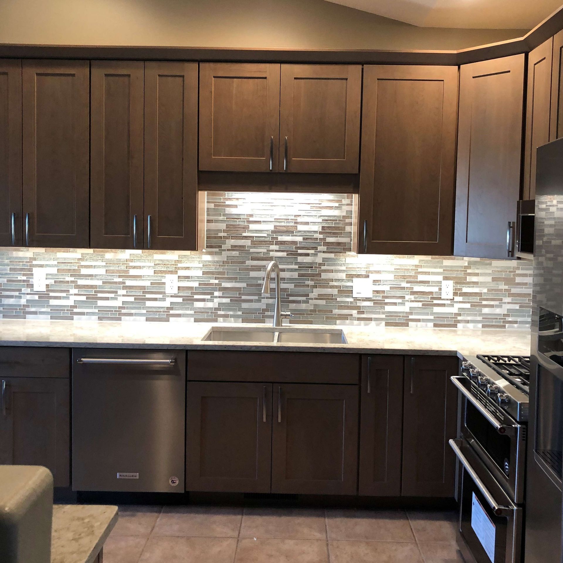 A kitchen with stainless steel appliances and wooden cabinets