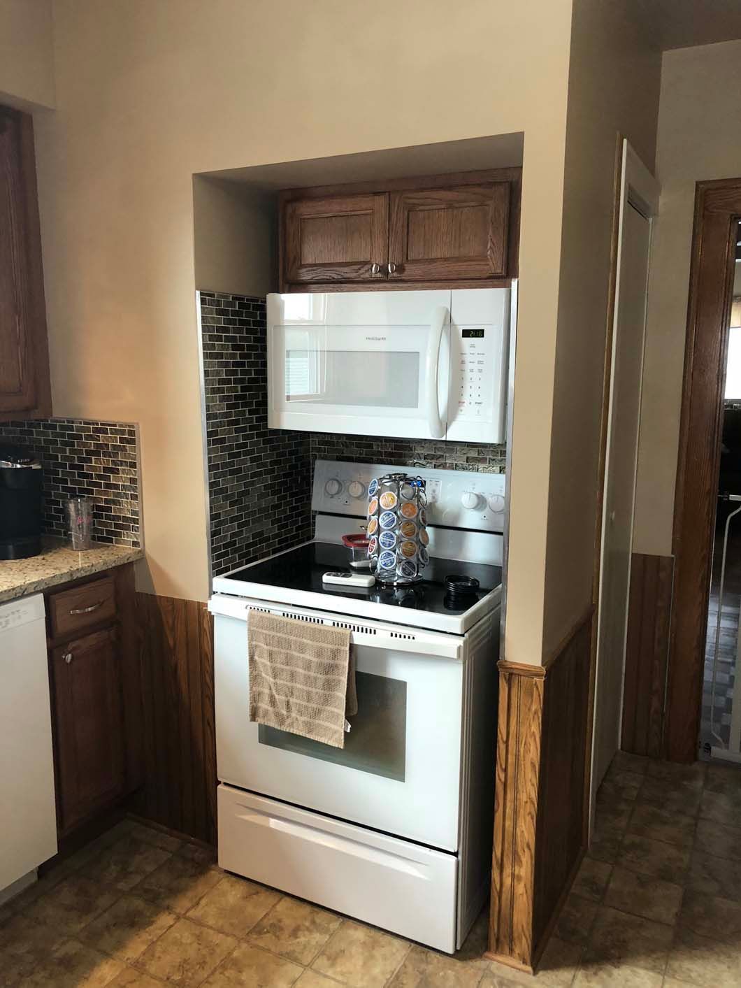 A kitchen with a stove , microwave , and dishwasher.