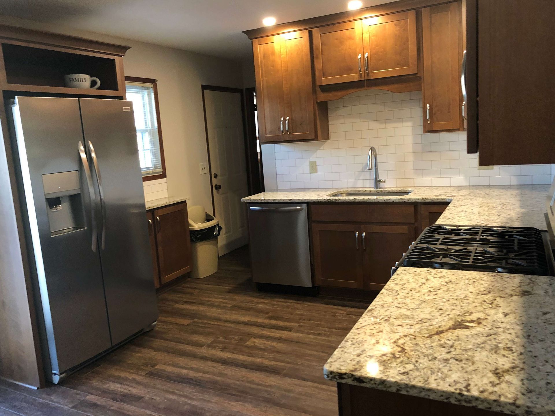 A kitchen with stainless steel appliances and granite counter tops.