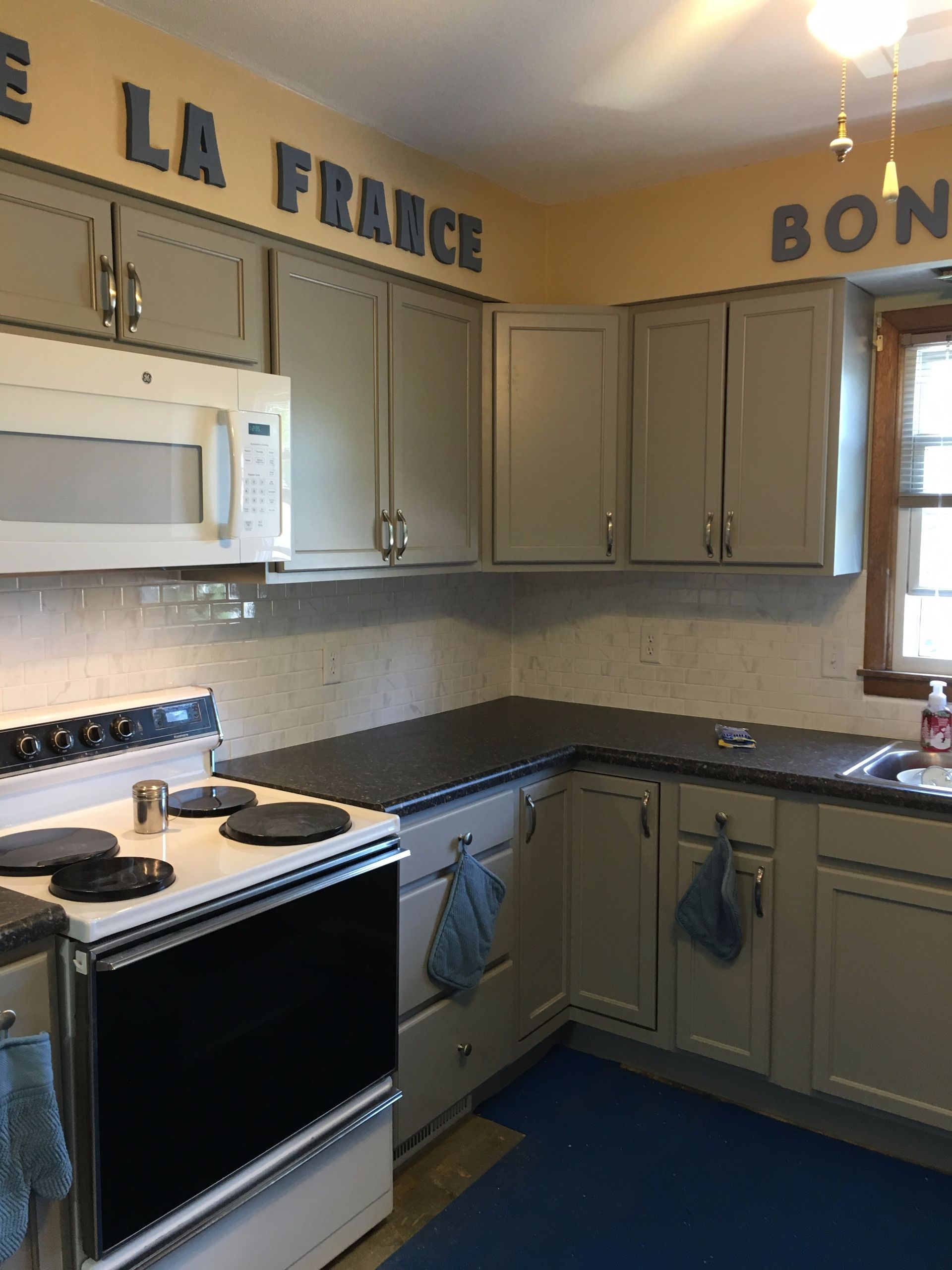 A kitchen with a sign that says la france on the wall