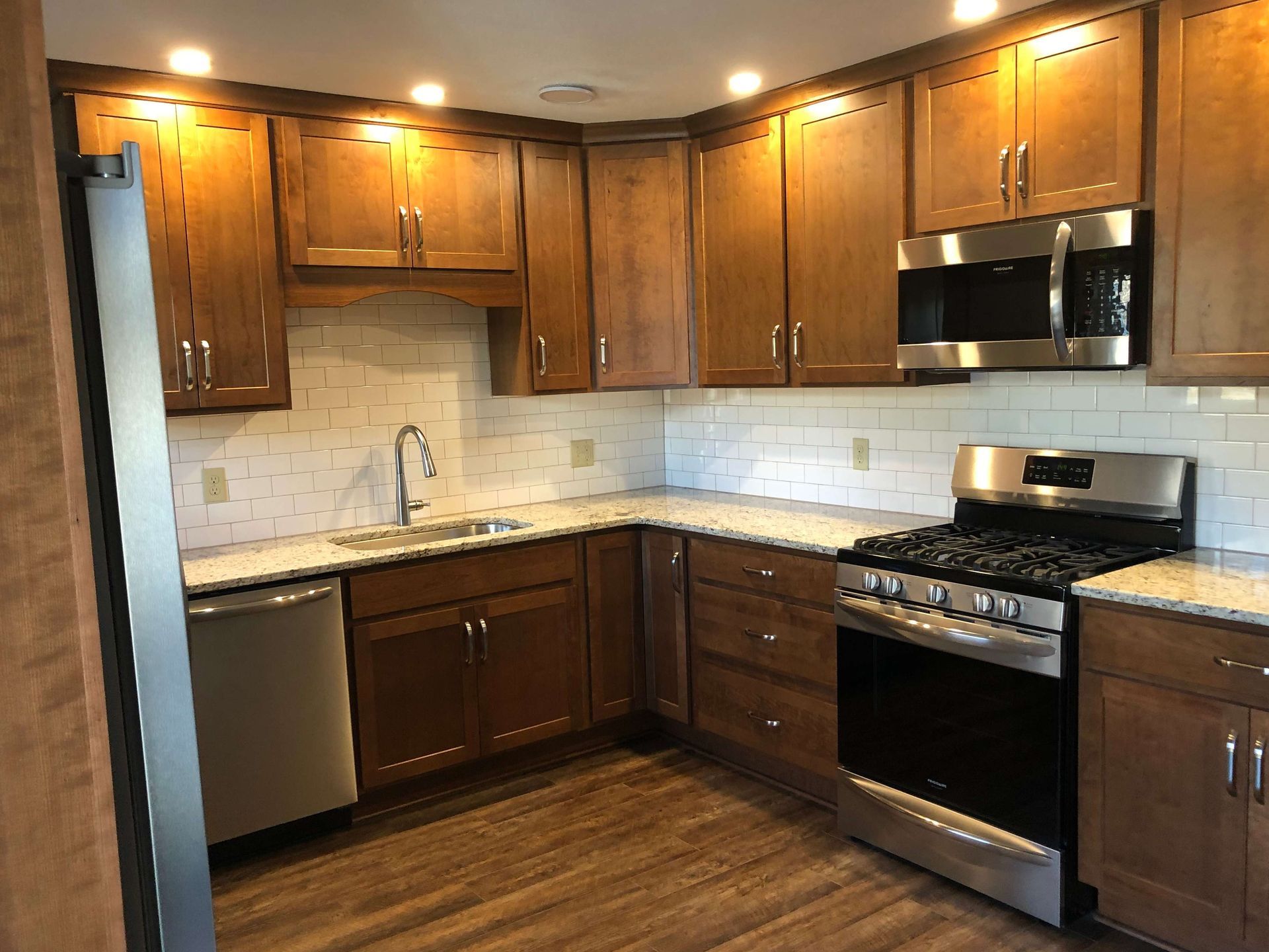 A kitchen with wooden cabinets and stainless steel appliances.