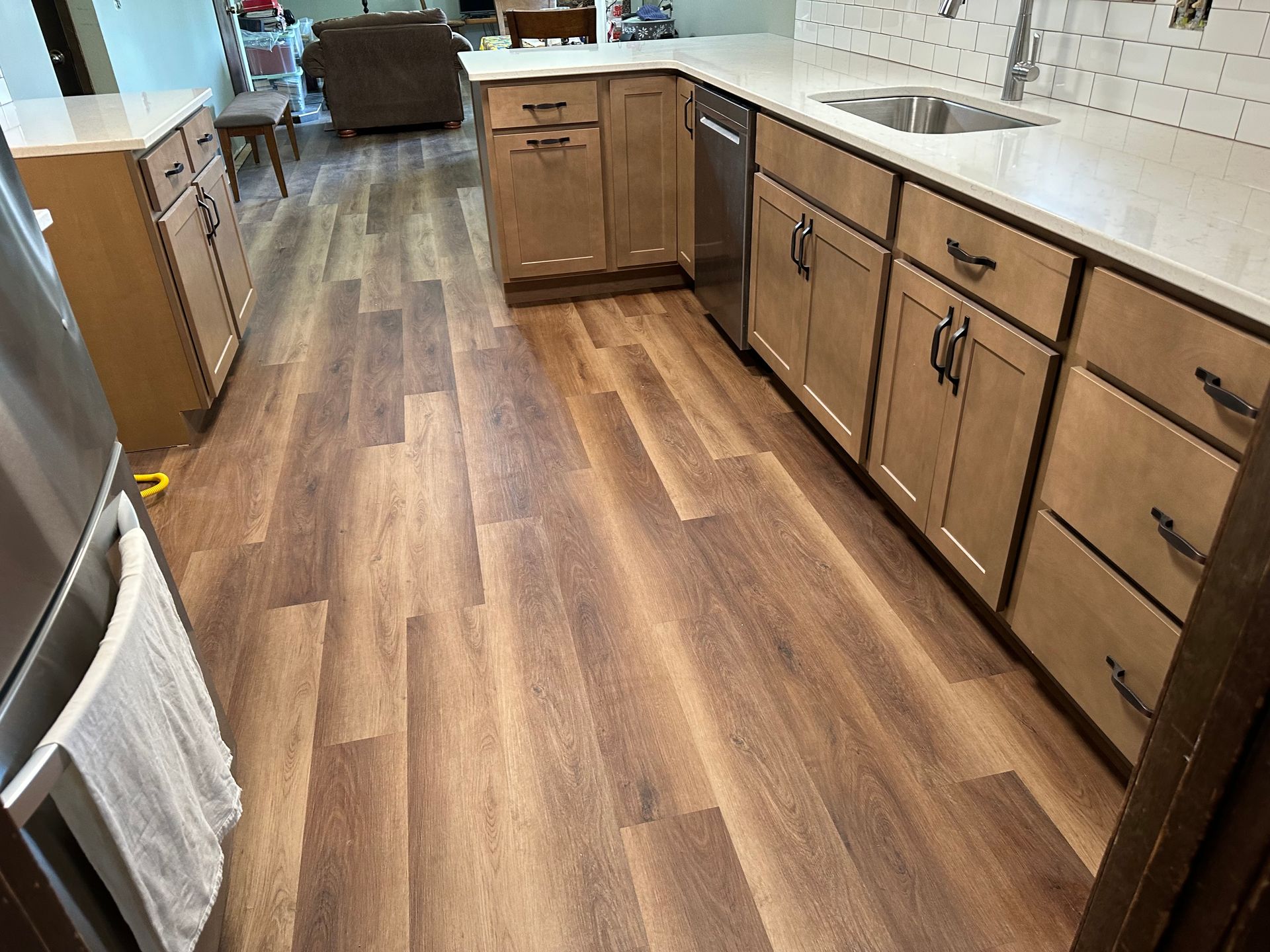 A kitchen with hardwood floors and stainless steel appliances.