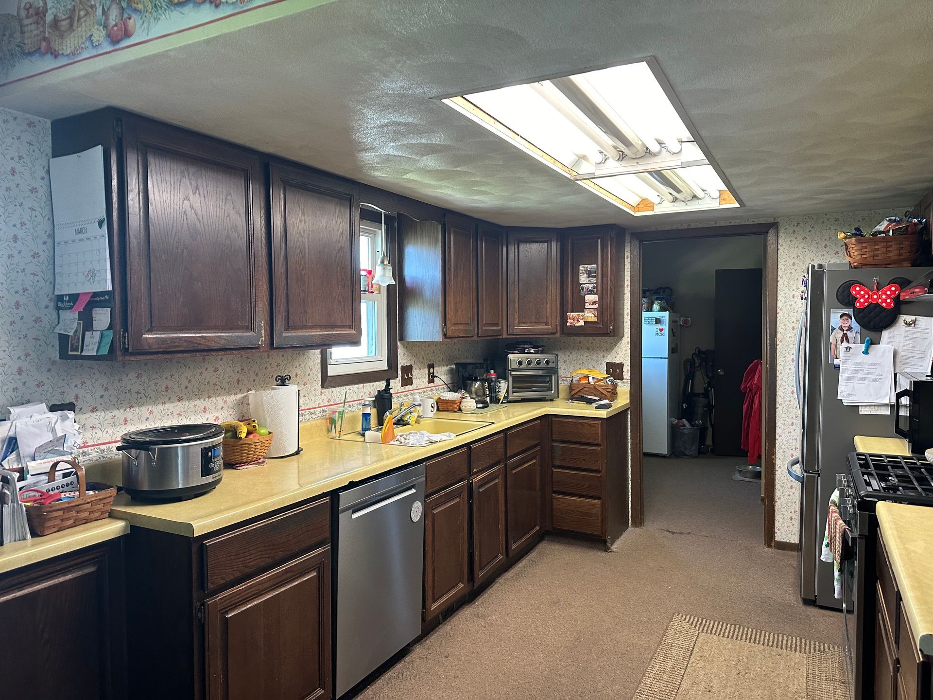 A kitchen with wooden cabinets and stainless steel appliances.