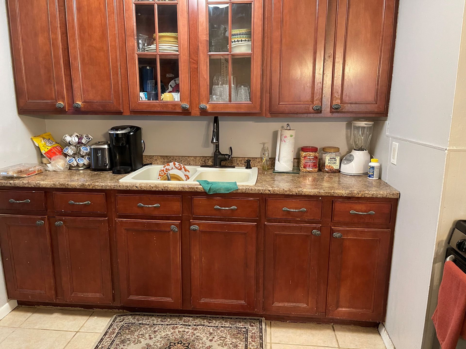 A kitchen with wooden cabinets and a sink.