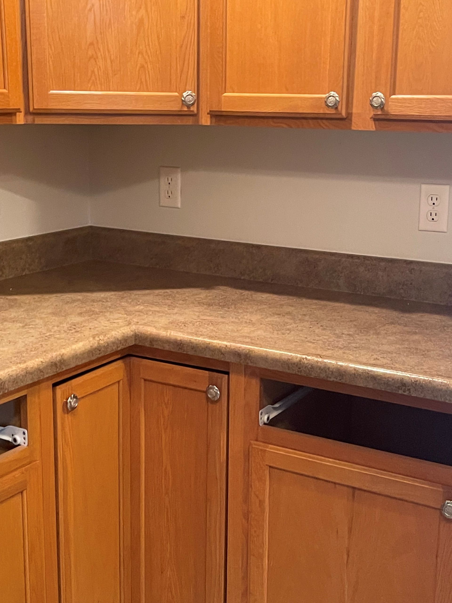 A kitchen with wooden cabinets and granite counter tops