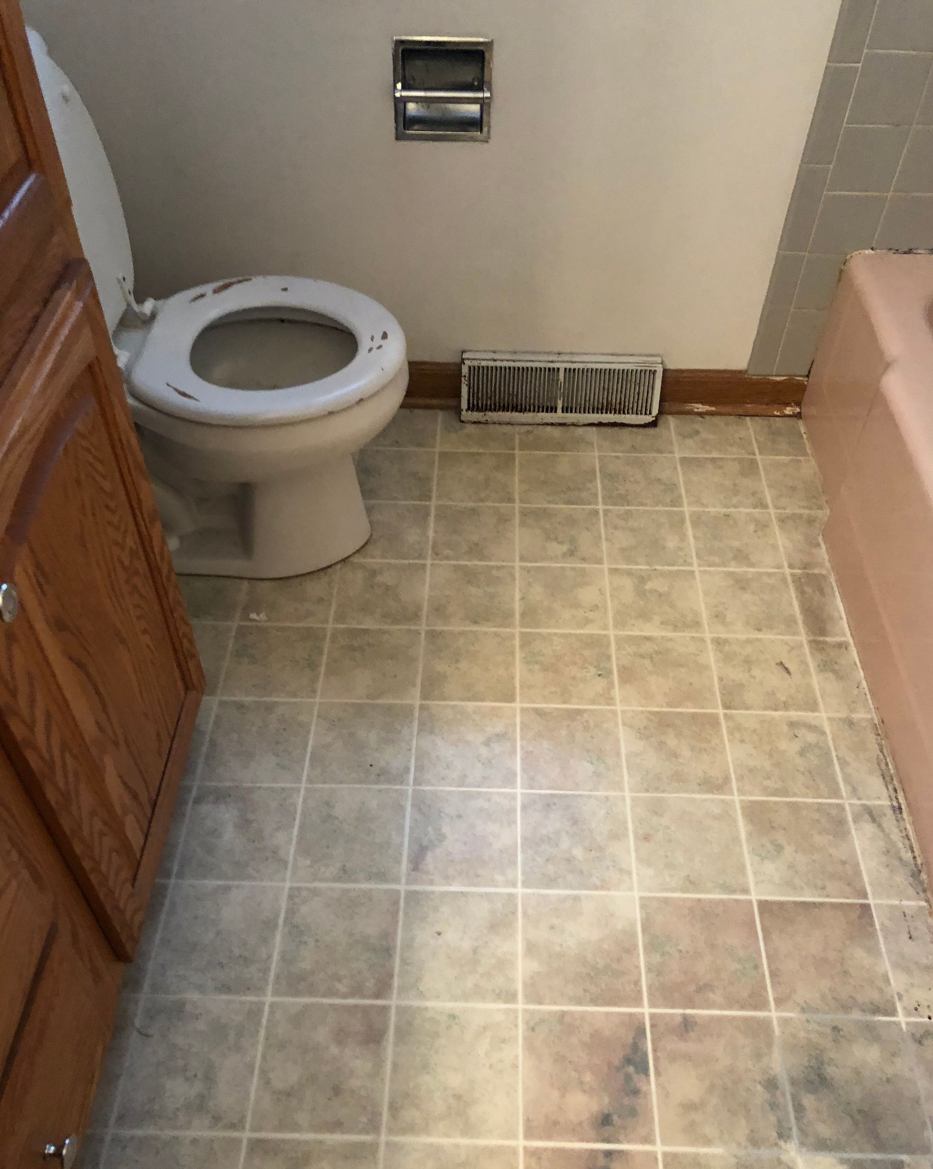 A bathroom with a toilet , sink , and bathtub.