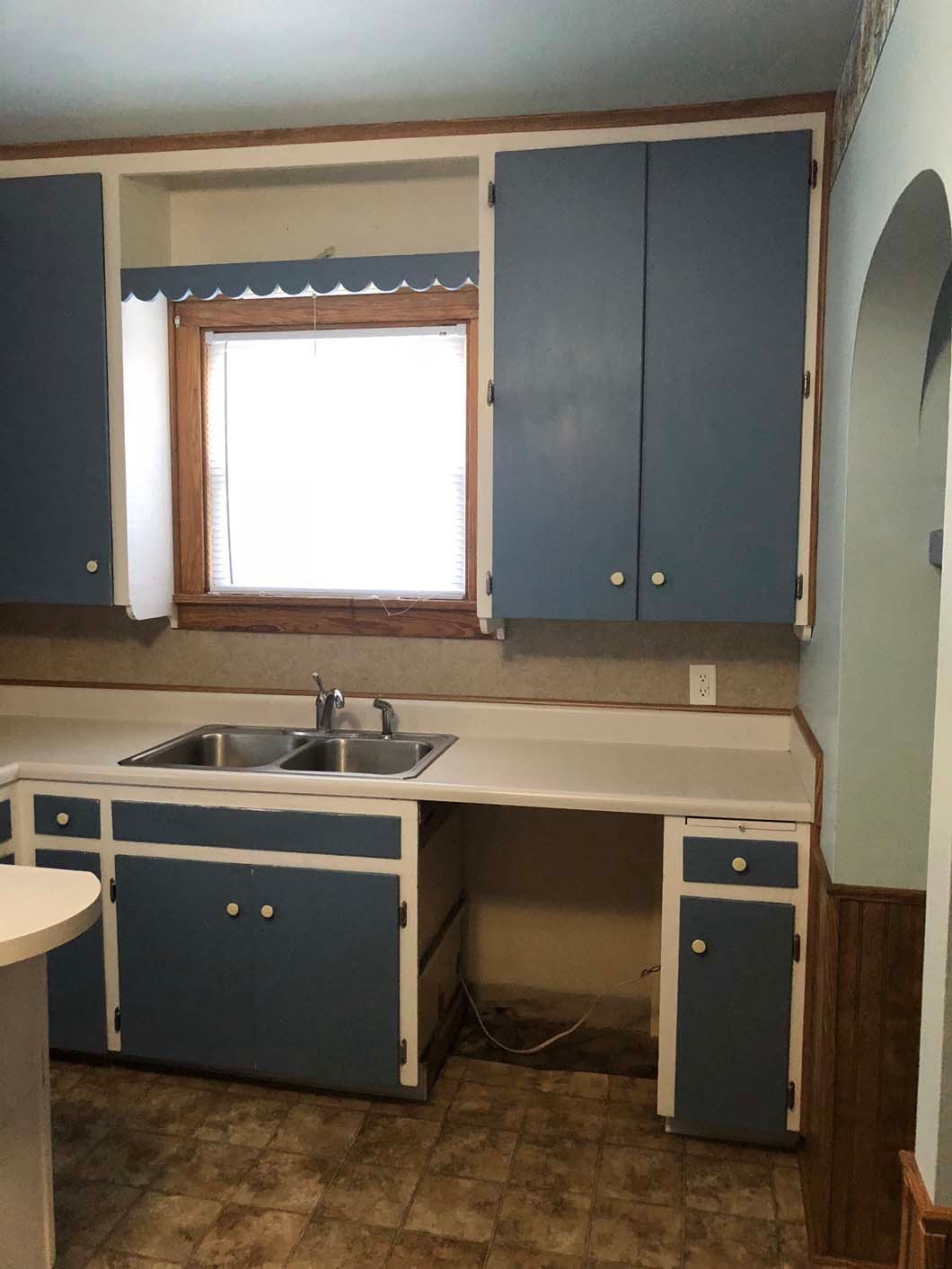 A kitchen with blue cabinets and a sink