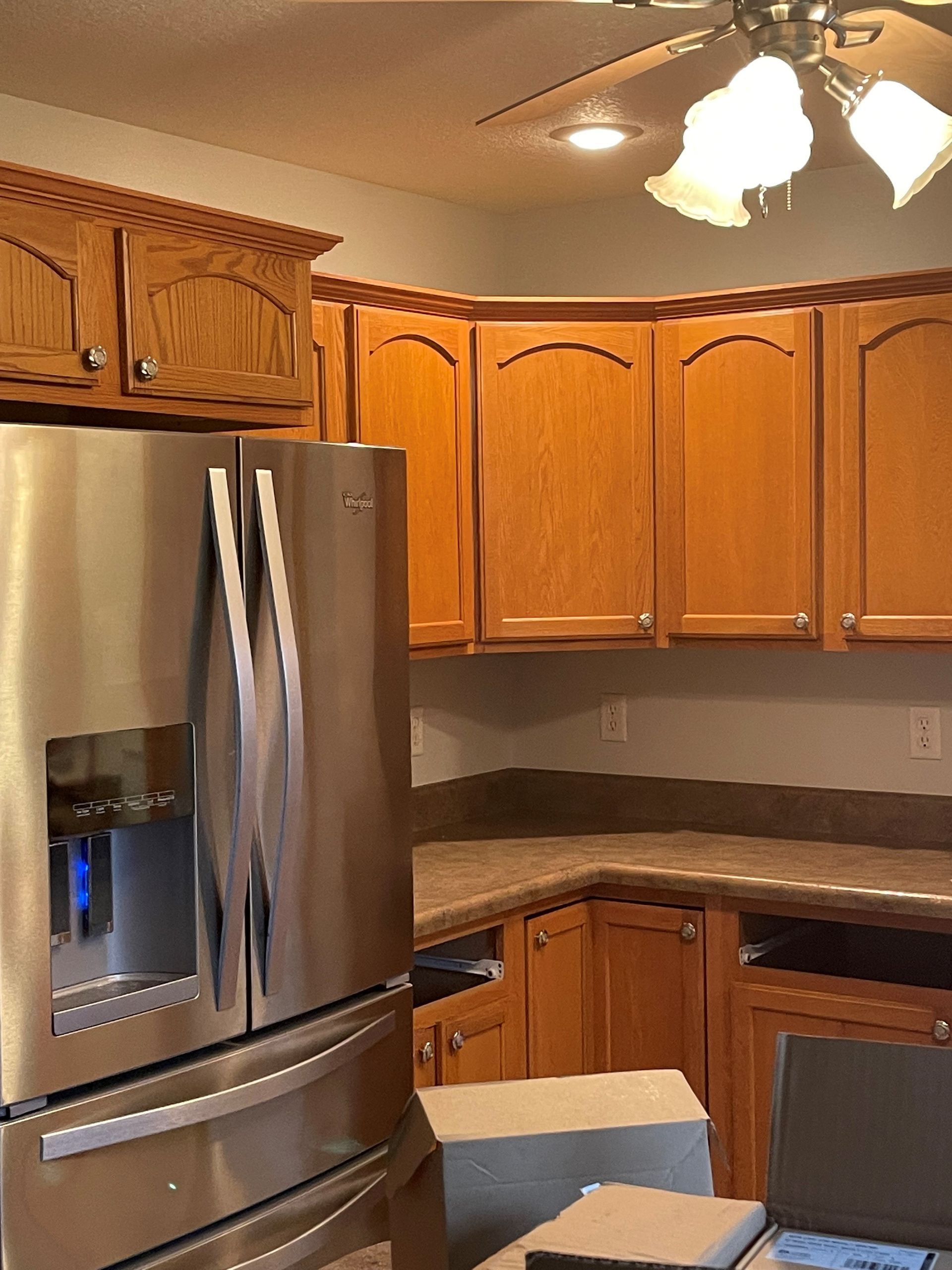 A kitchen with stainless steel appliances and wooden cabinets