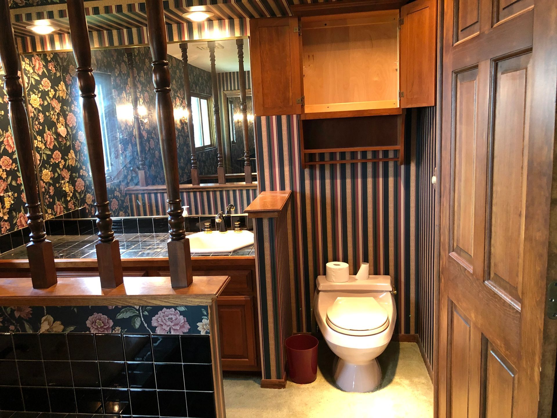 A bathroom with a toilet , sink and mirror