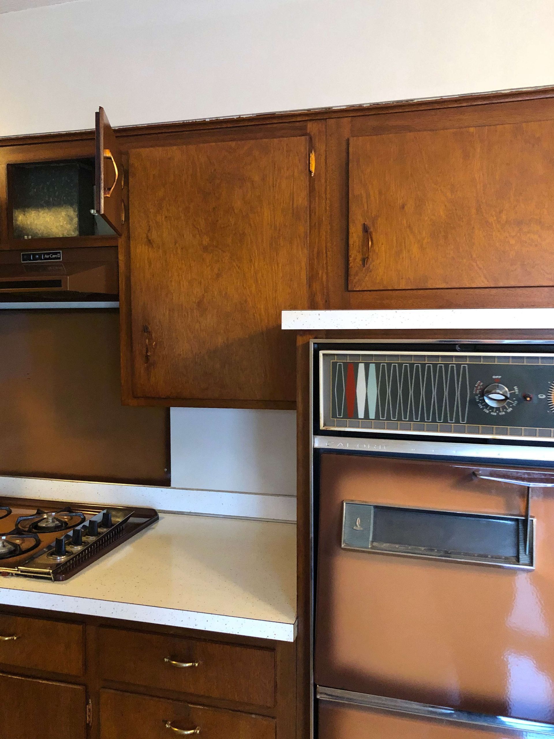 A kitchen with a stove top oven and a microwave